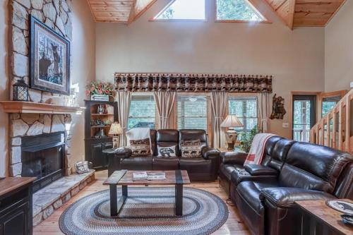 a living room with leather furniture and a fireplace at Oasis In the Mountains in Murphy