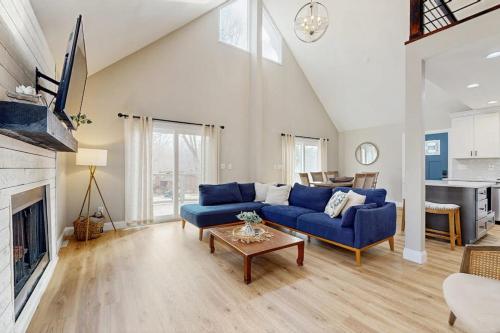 a living room with a blue couch and a table at Wildwood in Fletcher