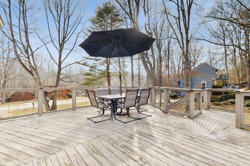 a table and chairs with an umbrella on a deck at Wildwood in Fletcher