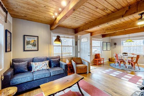 a living room with a couch and a table at Bryson Chalet in Bryson City