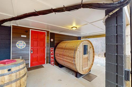 a large wooden boat in a room with a red door at Bryson Chalet in Bryson City