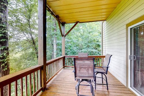 a porch with two chairs and a table on it at Link Vacation in Whittier