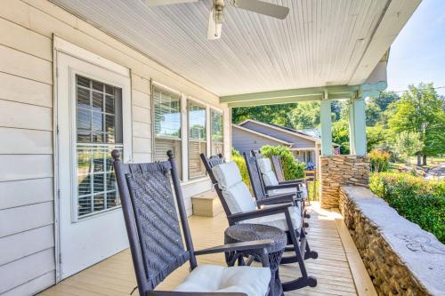 a row of rocking chairs sitting on a porch at Chapel Side in Lake Junaluska