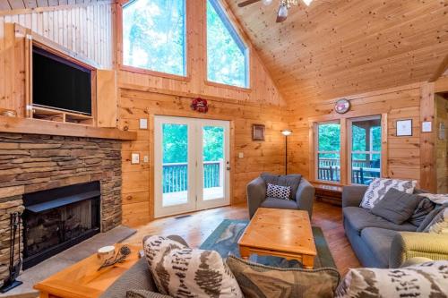 a living room with a fireplace and a tv at Wunderland Cabin in Lake Lure