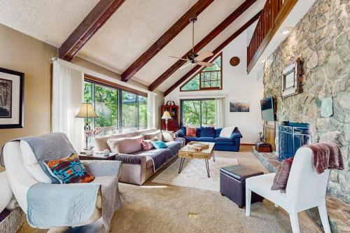 a large living room with a stone wall at Yopp's Treehouse in Lake Lure