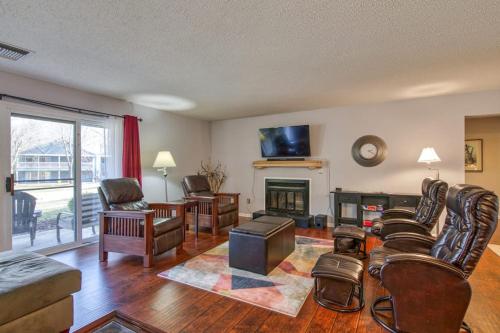 a living room with leather furniture and a fireplace at Beehive Condo in Lake Junaluska