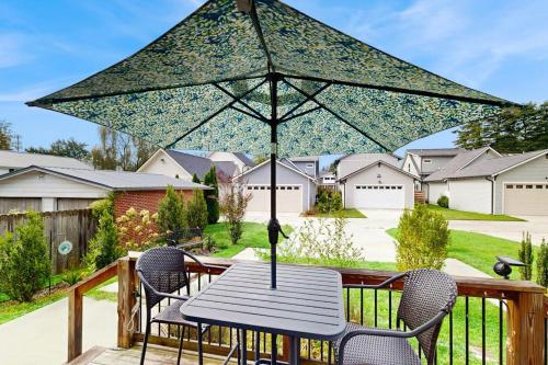 a table and chairs with an umbrella on a deck at Downtown Delight in Brevard