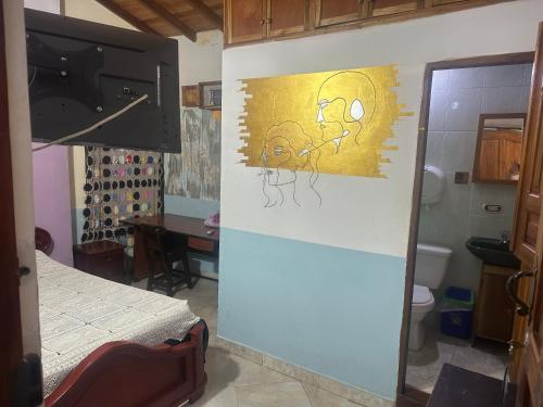 a kitchen with a painting on the wall at Hotel Atenas in Jericó