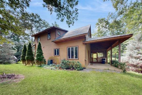 a wooden house with a porch and a lawn at Rhymer Haven in Juno