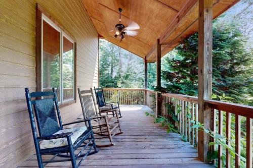 a porch with two chairs and a ceiling fan at Rhymer Haven in Juno