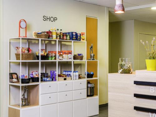 a shelf with food items on it in a store at Aparthotel Adagio Access Paris Asnières in Asnières-sur-Seine