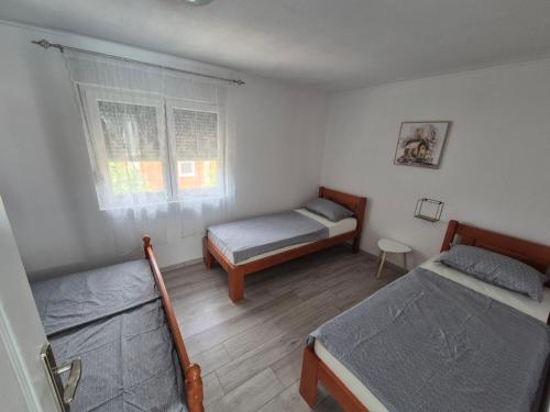 a bedroom with two beds and a window at Holiday Home Dalia with Private Pool in Blagaj
