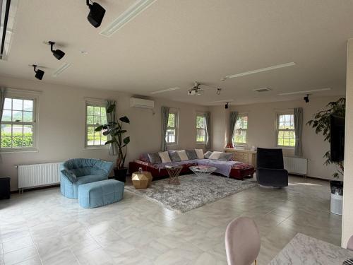 a large living room with a couch and chairs at Lei Toya in Sobetsu