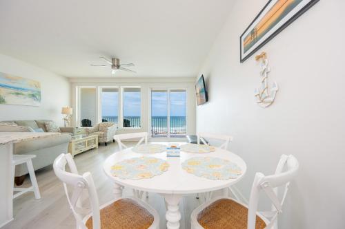 a white dining room with a table and chairs at Sea Glass 305 in Gulf Shores
