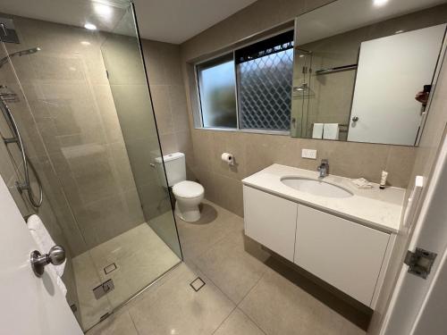 a bathroom with a shower and a sink and a toilet at Clearwater Noosa Resort in Noosaville