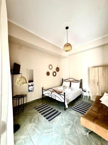 a bedroom with a bed and a couch at Olea Central Stay in Nea Kallikrateia