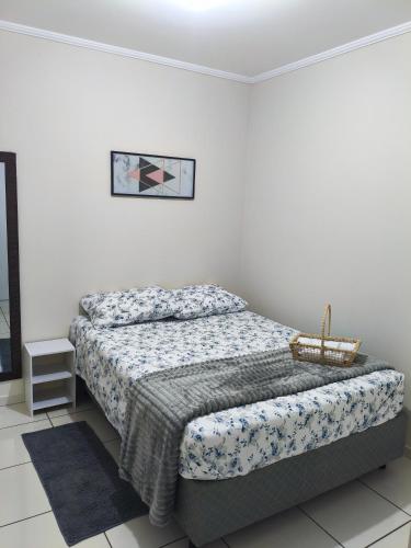 a bedroom with a bed in a white room at Apartamento central 1 quarto in Passo Fundo