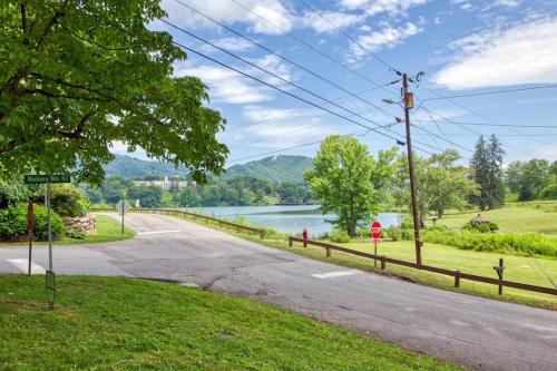an empty road with a view of a lake at Cameron Lakeside in Lake Junaluska