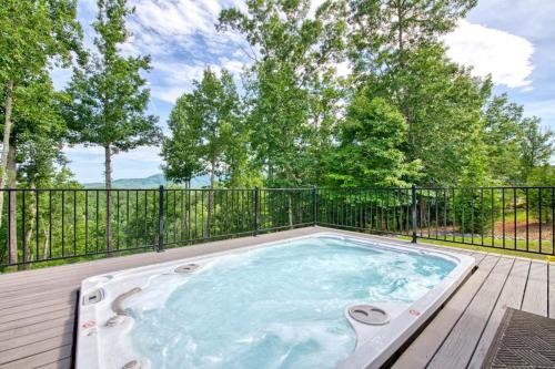 a hot tub on a deck with a fence at Mountain Majesty in Mill Spring