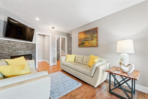 a living room with a couch and a fireplace at Upper Lakeshore Living in Lake Junaluska