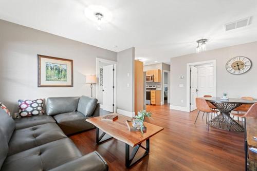 a living room with a couch and a table at Lower Lakeshore Living in Lake Junaluska
