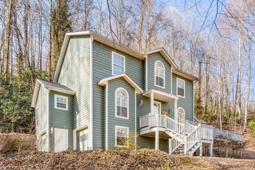 a large green house with a balcony on a hill at Cherry Tree Lodge in Black Mountain