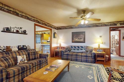 a living room with two couches and a ceiling fan at Humming Bird Crossing in Scaly Mountain