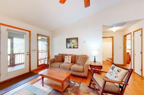 a living room with a couch and a table at Raven's Respite in Saluda