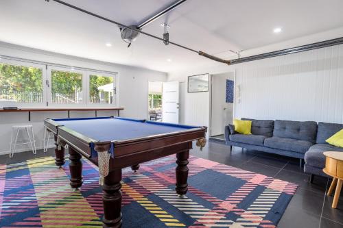 a living room with a pool table in it at SeaBreeze On Todd in Yeppoon