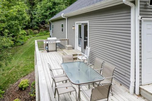a deck with a table and chairs on a house at Hilltop Hideaway in Asheville