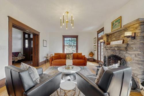 a living room with a couch and a fireplace at Love Lane Tudor in Waynesville