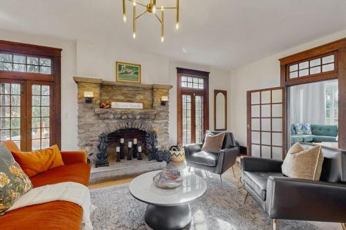 a living room with a couch and a fireplace at Love Lane Tudor in Waynesville