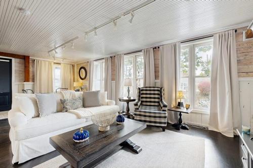 a living room with a white couch and a table at Sassafras Cottage in Waynesville