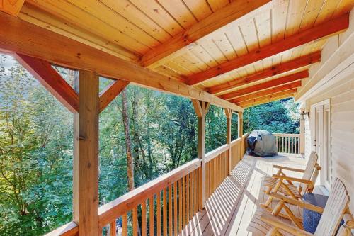 a porch of a cabin with a wooden ceiling at Smoky View Retreat in Maggie Valley