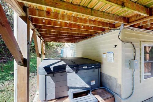 a barbecue grill sitting under a wooden roof at Smoky View Retreat in Maggie Valley