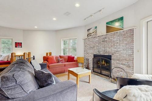 a living room with a couch and a fireplace at Circular Mountain Retreat in Brevard