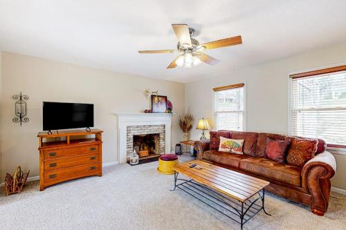 a living room with a couch and a fireplace at Come Together Place in Candler