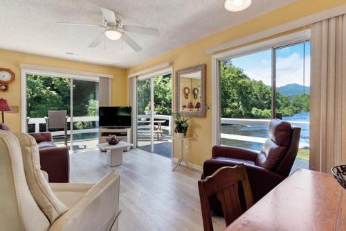 a living room with a couch and chairs and a television at 2 Bed 1 Bath Vacation home in Sylva in Sylva