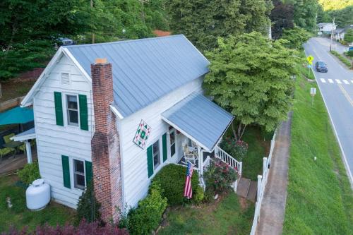 an aerial view of a white house with a blue roof at The Reed House in Dillsboro