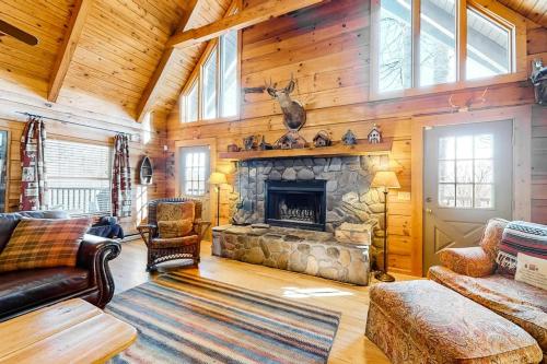a living room with a stone fireplace in a cabin at Timberidge Lodge in Sylva