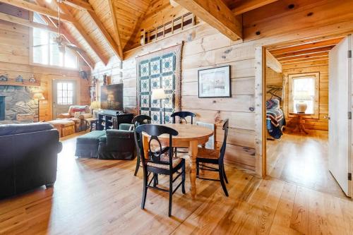 a dining room and living room with a table and chairs at Timberidge Lodge in Sylva