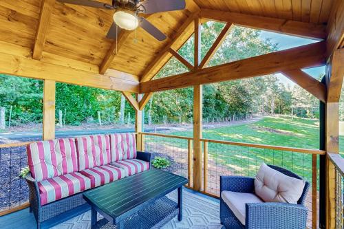 a screened in porch with a couch and a table at Phobos Cabin in Mars Hill