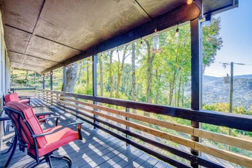 a porch with chairs and a view of the mountains at Chipmunk Lane in Maggie Valley