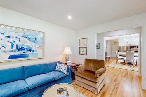 a living room with a blue couch and a chair at Blue Ridge Cottage in Waynesville