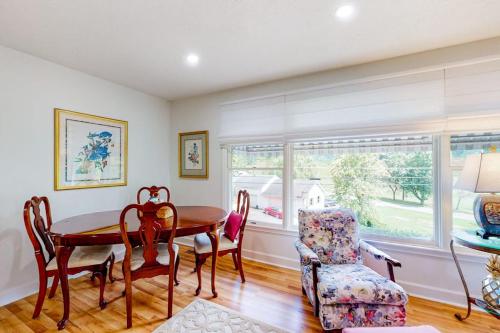 a dining room with a table and a chair at Blue Ridge Cottage in Waynesville