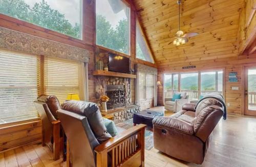 a living room with leather furniture and a fireplace at 4 Bed 4 Bath Vacation home in Sylva in Sylva