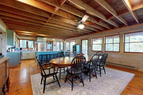 a kitchen and dining room with a table and chairs at Merrywoode in Lake Toxaway