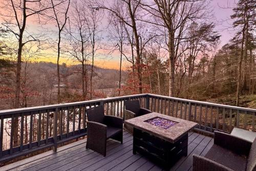 a wooden deck with a table and chairs on a balcony at Lake Emory Gem in Franklin