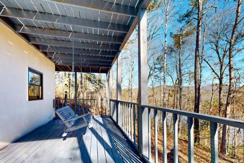 a wooden porch with a bench on a deck at Lake Emory Gem in Franklin