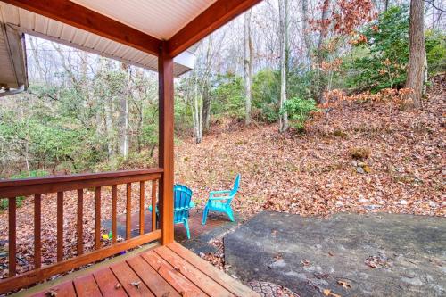a porch with a blue chair on a deck at Trimont Mountain Cottage in Franklin